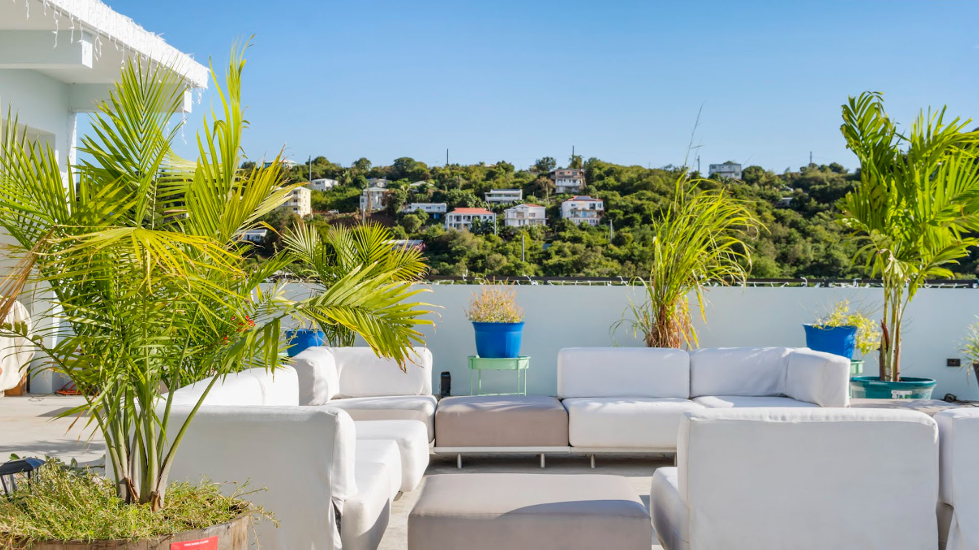Modern rooftop seating area with hillside views
